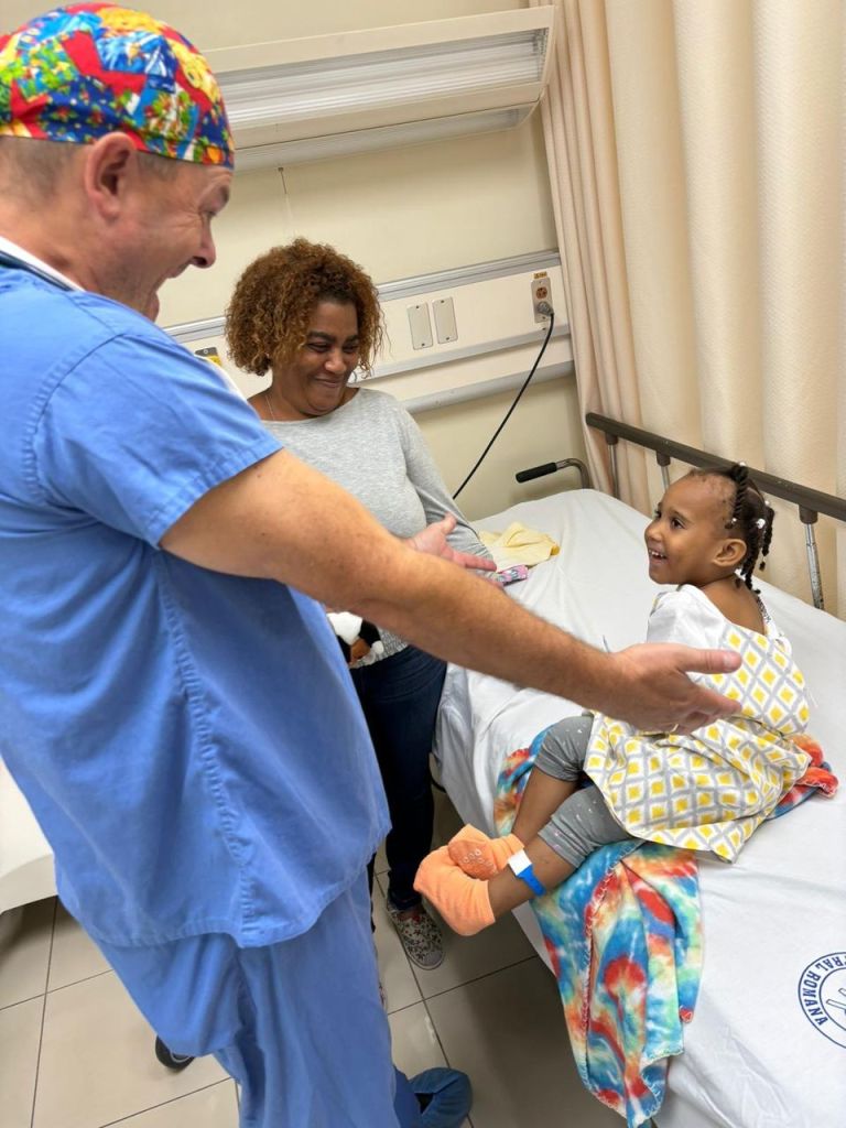 Doctor greeting child at a hospital