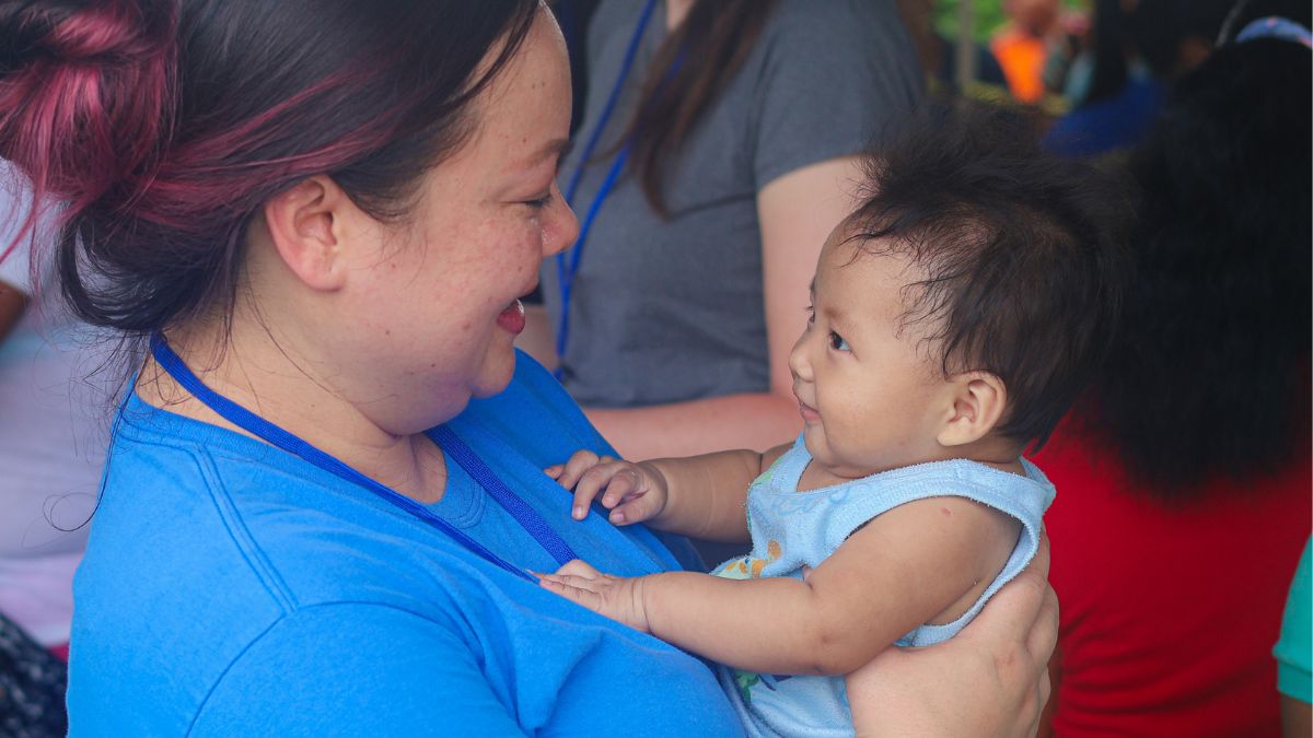 Woman holding baby in Panama, showing prenatal vitamins for maternal health at MAP International