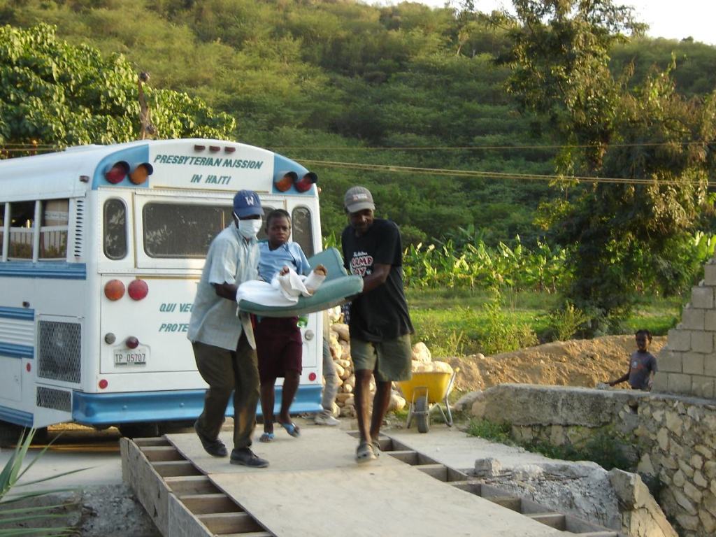 Patient carried by medical staff in Haiti, showcasing MAP International's relief for humanitarian crisis