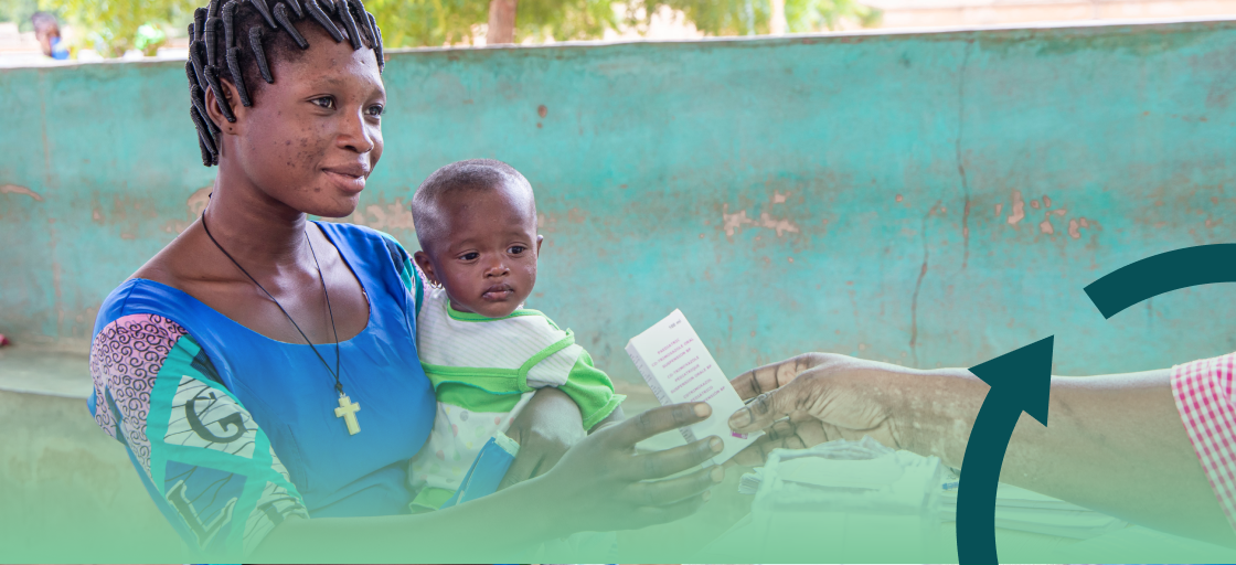 A mother holding her child receives medicine at a MAP partner clinic